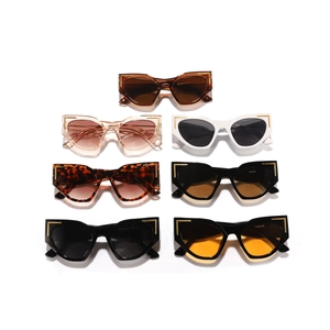 Detailed close-up of colorful cat eye sunglasses featuring gold metal L-shaped accents