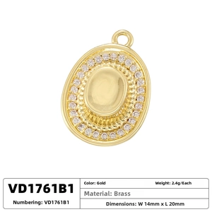 Detailed view of an oval gold brass pendant with white zircon stones measuring 14x20mm