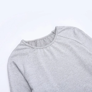 Close-up of gray yoga top neckline featuring raglan sleeves and fine knit texture