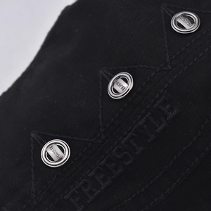 Detail of black fabric with silver metal eyelets and FREESTYLE embroidery on the hat