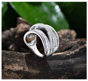 Macro detail of multi-layer silver wide ring with zircon pavé on natural wood