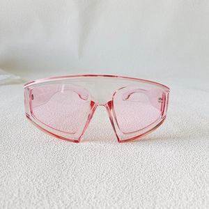 Detail of pink oversized shield sunglasses with gradient lenses and a one-piece frame