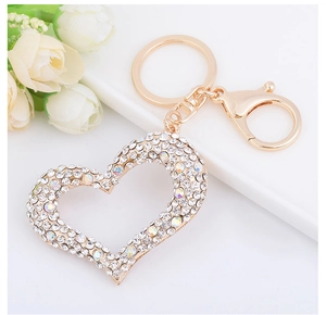 Detail of a sparkling heart keychain with clear crystals and a gold lobster clasp