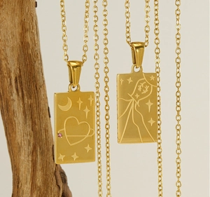 Macro detail of 18K gold stainless steel tarot pendant with engraved celestial patterns