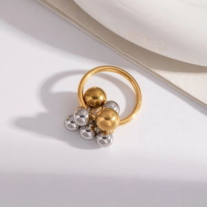 Minimalist polished steel ring with two-tone gold and silver beaded clusters on white