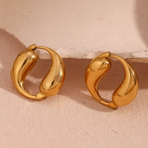 Detailed macro view of 18K gold-plated stainless steel teardrop hoop earrings on pink background