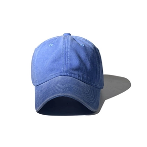 Detail of the washed navy blue cotton baseball cap with curved brim and vintage texture