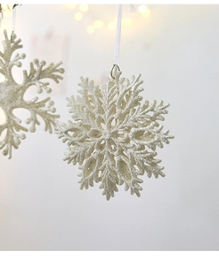 Macro view of glittering silver snowflake ornaments with ribbon on a Christmas tree