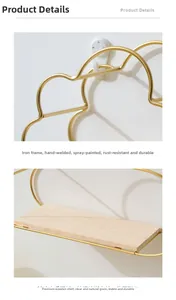 Cloud-shaped gold iron wall shelf detail with hand-welded frame and natural wood board