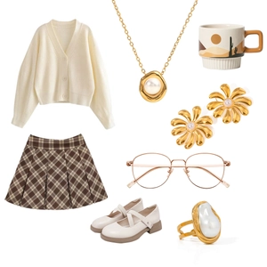 Flat lay of stainless steel pearl jewelry set with gold ring, earrings and necklace