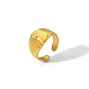 Detail of gold hammered stainless steel open ring with vertical textured patterns