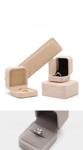Macro detail of plush velvet jewelry boxes for rings and necklaces in pink and grey