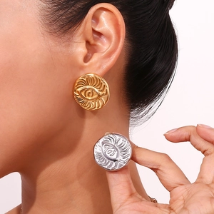 Close-up of geometric solar pattern on 18K gold and silver petal earrings