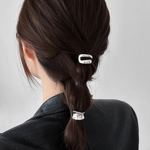 Minimalist silver liquid metal ponytail hair clips set on woman with dark brown hair