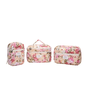 Three-piece floral quilted makeup bag set in beige with pink and yellow flowers
