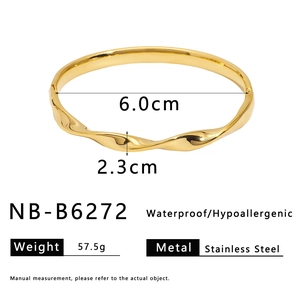 Macro detail of gold stainless steel twisted wide cuff bracelet with zircon inlay