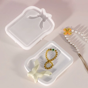 Macro detail of silicone bowknot tray mold showing smooth resin jewelry storage surface
