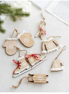Detailed flat lay of wooden Christmas pendants featuring skates and sled on beige tabletop