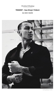Close-up of a silver trident pendant and chain bracelet worn by a man for a punk look