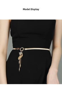 Detail of gold elastic waist chain featuring a rhinestone fox pendant and metallic tassels