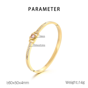 Detail view of gold heart bangle with pink glass stone and rhinestone inlay specifications