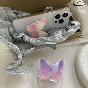 Close-up of glittery butterfly phone sockets in pink and purple gradient on a phone