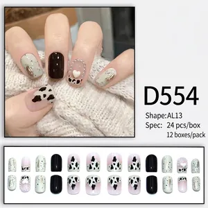 French press-on nails with cow print and pearl heart accents in black and pink design
