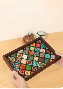 Detail of bohemian wooden tray with colorful tile patterns being held in hands