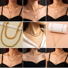 Collage of multi-layered stainless steel necklaces featuring gold butterflies and pearls