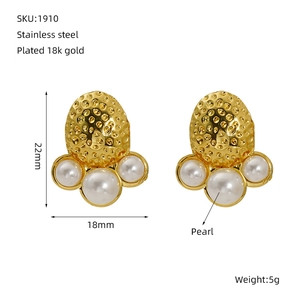 Macro detail of 18K gold plated stainless steel textured earrings with white pearl accents