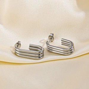 Three-layered silver geometric U-shaped titanium steel earrings on luxury silk fabric