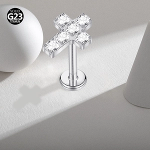 Detail of silver G23 titanium cross stud earring featuring sparkling clear cubic zirconia