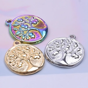 Detailed view of tree of life pendants in rainbow, gold, and silver stainless steel