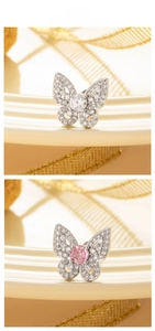 Detail of butterfly earring with silver base and full cubic zirconia inlay on a tray