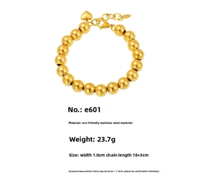 Detail of 18k gold plated hollow beads bracelet featuring heart charm and lobster clasp