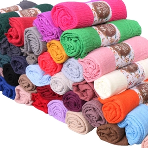 Colorful crinkled cotton scarves for women in various shades with frayed edges