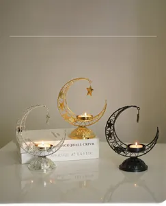 Detail of crescent moon incense holders in gold silver and black with hanging star design
