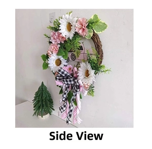 Side view of Christmas wreath featuring a pink truck and white sunflower details