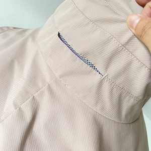 Detail of breathable mesh lining and ripstop fabric on a beige sun protection hat