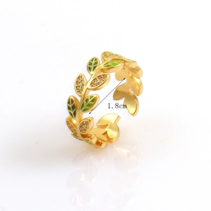 Detailed macro view of 18k gold leaf ring with green enamel and zircon stones, 1.8cm diameter