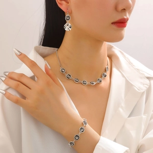 Fashion jewelry set with square black stones, necklace, bracelet and earrings on model