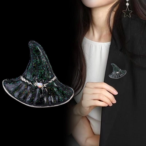 Glittery black witch hat brooch with magic gem shown on black blazer for Halloween
