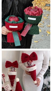 Macro detail of knit Christmas gift bags and plush red bow holiday decorations