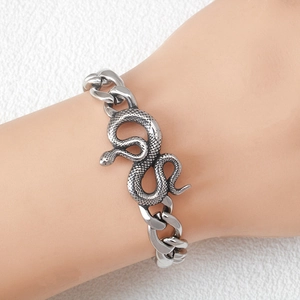 Silver stainless steel Cuban chain bracelet featuring a detailed coiled snake charm