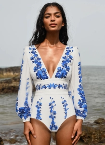 Detail of floral long sleeve one-piece swimsuit with V-neck and beach holiday vibes