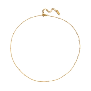 Detail of gold stainless steel bead chain necklace with extension and lobster clasp