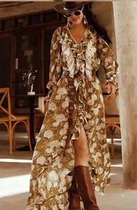 Detail of a vintage style brown leather belt with a floral print maxi dress and boots