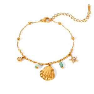 Detail of gold bead bracelet featuring shell, rhinestone star and green stone pendants