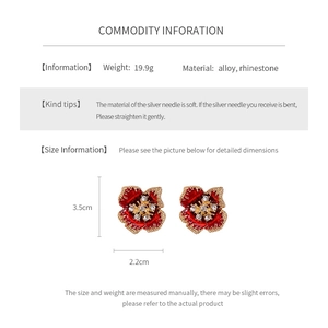 Detail of vintage enamel flower earrings with gold edges and sparkling rhinestones