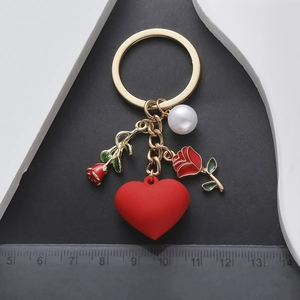 Detail view of heart and rose keychain with measuring ruler showing 11cm length